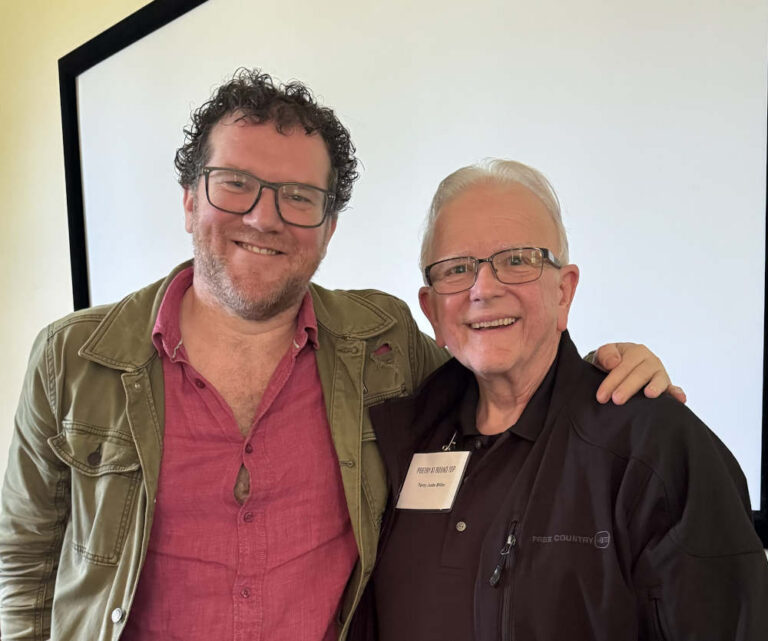 Terry poses smiling beside Pádraig O Tuama.